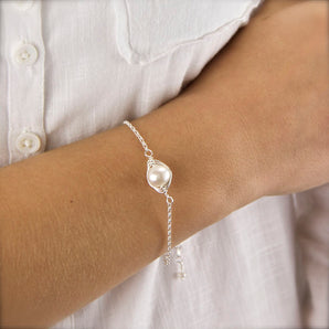 Wrapped Pearl Silver Bracelet shown worn around a model's wrist