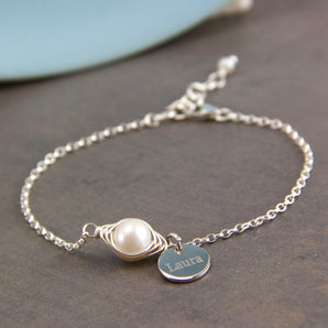 Wrapped Pearl Silver Bracelet with engraved disc charm displayed on a grey background