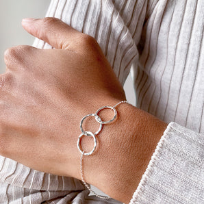 Three Linked Circles Sterling Silver Bracelet shown worn around a model's wrist
