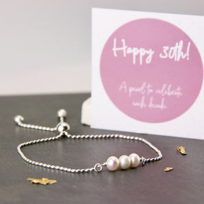 30th Birthday Pearl Sliding Bracelet shown with product insert card