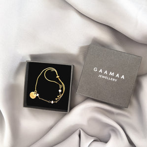 Delicate Pearl Sliding Bracelet with engraved disc charm displayed in a gift box