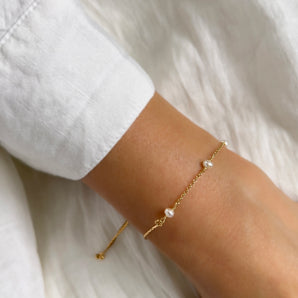 Delicate Pearl Sliding Bracelet shown worn around a model's wrist