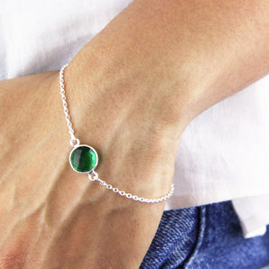 Emerald bracelet shown worn around a wrist