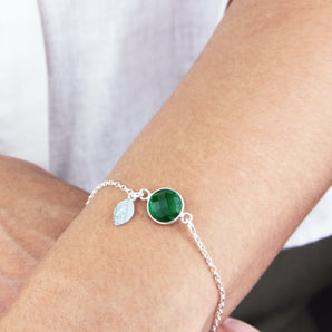 May Birthstone And Initial Leaf Sterling Silver Bracelet shown worn around a model's wrist