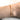Gold bracelet with two initials on model's wrist