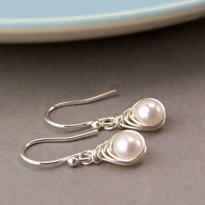 Close up view of All Wrapped Up White Pearl and Silver Earrings