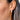 Pearl hoop huggie earrings with silver posts and backs shown worn in a models ear