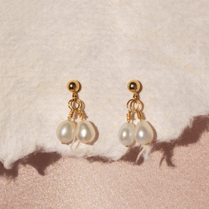 Close up view of gold Twin Pearl Drops Stud Earrings