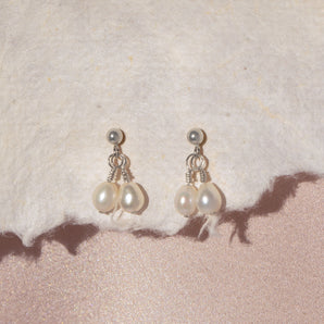 Close up view of silver Twin Pearl Drops Stud Earrings