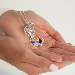 Open locket with 6 assorted birthstones displayed on the palm of a hand