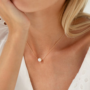 Gold Filled Floating Pearl Necklace shown worn around a model's neck