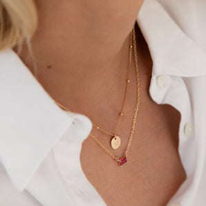 Gold Birthstone Baguette Necklace shown worn around a model's neck