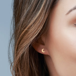 Gold Filled Crescent Moon Stud Earrings shown worn in a model's ear