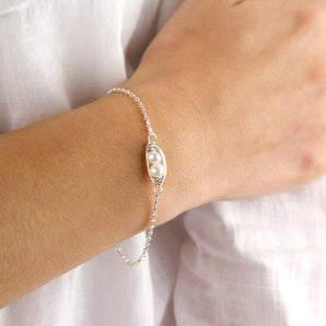Sterling Silver And Pearl Peapod Bracelet shown worn around a model's wrist
