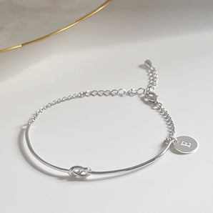 Personalised Knot Bangle Bracelet displayed on a white surface