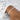 Close-up of a wrist wearing a seed pearl bracelet with a white textured fabric background.