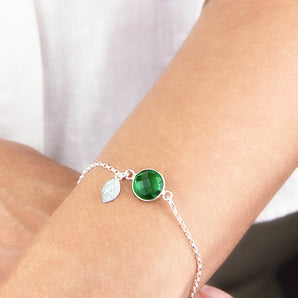 May Birthstone And Initial Leaf Sterling Silver Bracelet shown worn around a model's wrist