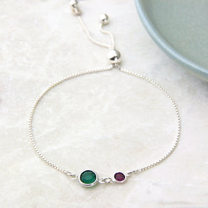 Adjustable silver bracelet with emerald and amethyst birthstones