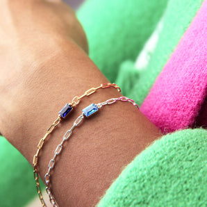 Gold and silver Baguette Birthstone Bracelets worn around a model's wrist