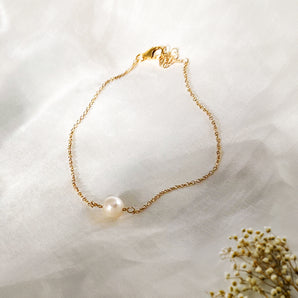Gold Filled Pearl Bracelet displayed on a white fabric background