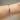 Person wearing silver bracelet with pink baguette stone