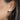 Close-up of an ear wearing a pearl stud earring.