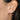 person wearing silver earrings with 3 hearts