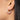 Silver hoop earring with red garnetb gemstones worn by a person