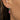 Large and small birthstones earrings on model's ear