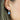 Blue Chalcedony semi-precious birthstone earring with silver hoop shown worn on the model's ear