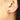 May Baguette Birthstone Pull Through Huggie Hoop Earrings shown worn in a model's ear