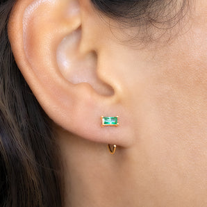 May Baguette Birthstone Pull Through Huggie Hoop Earrings shown worn in a model's ear