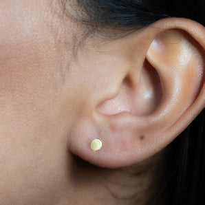 Gold Filled Circle Stud Earrings shown worn in a model's ear