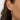 a person wearing mother and child birthstone earrings