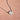 Silver necklace with an angel wing pendant on a pink background