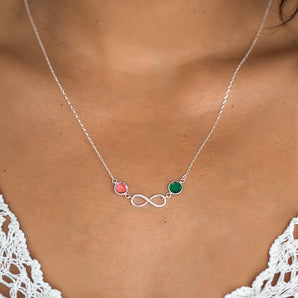 Model wearing silver infinity necklace with birthstones