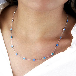 Sterling silver necklace with 19 opals shown worn around a model's neck