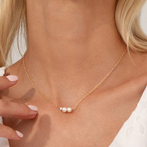 Gold 21st Birthday Floating Pearls Necklace shown worn around a model's neck