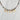 Necklace with gold letter charms spelling a name on a light grey background